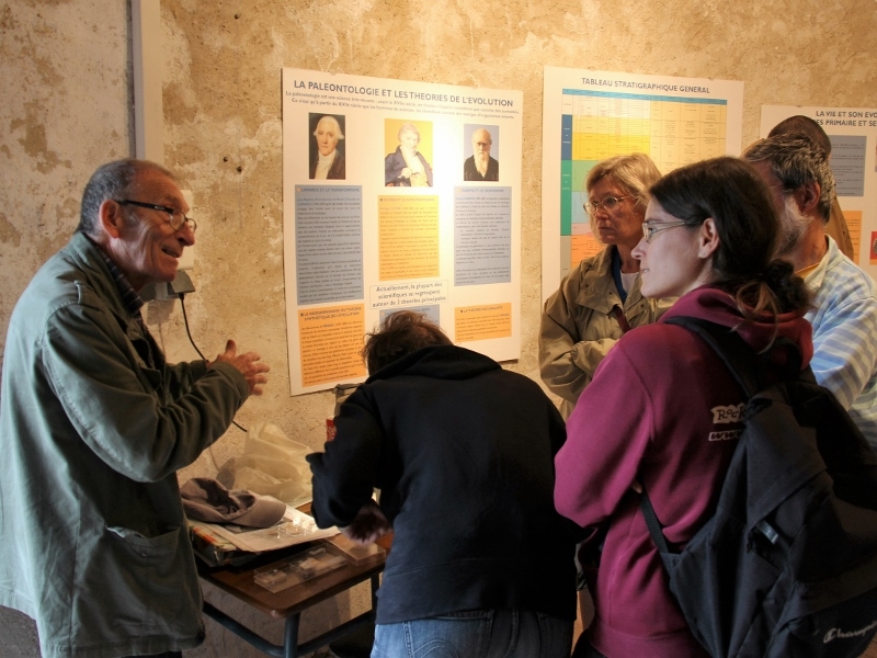 Au pigeonnier, Hervé intéresse le public aux fossilles à travers une Binoculaire - Photo Claude HY